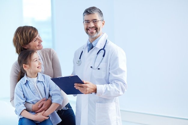 happy-doctor-holding-clipboard-with-patients_1098-2176.jpg